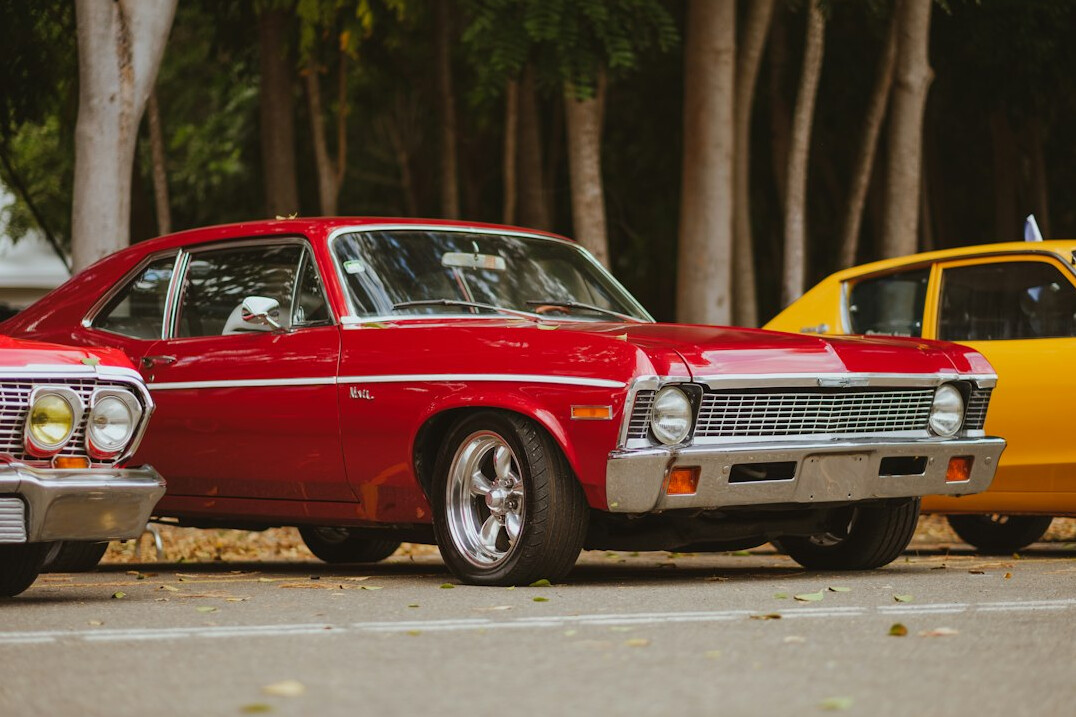 Row of classic cars parked at an outdoor automobile gathering