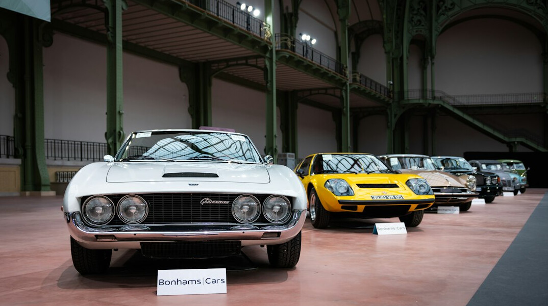 Private collection of classic automobiles under soft gallery lighting