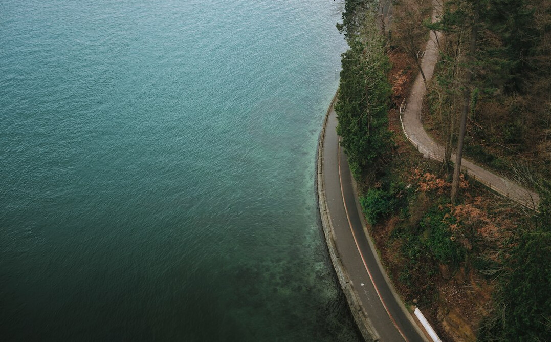 Aerial view of a coastal road winding along the shoreline