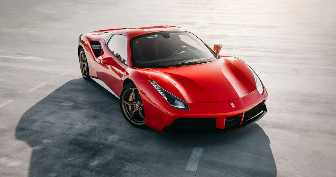Red Italian sports car parked on an empty street