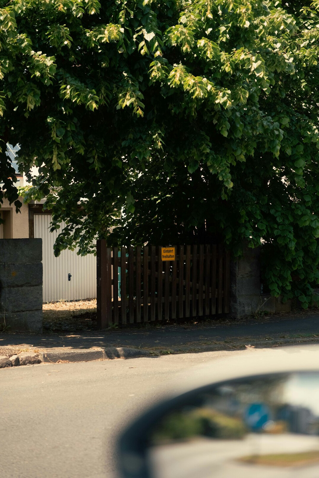 Dimly lit private garage with a covered classic automobile