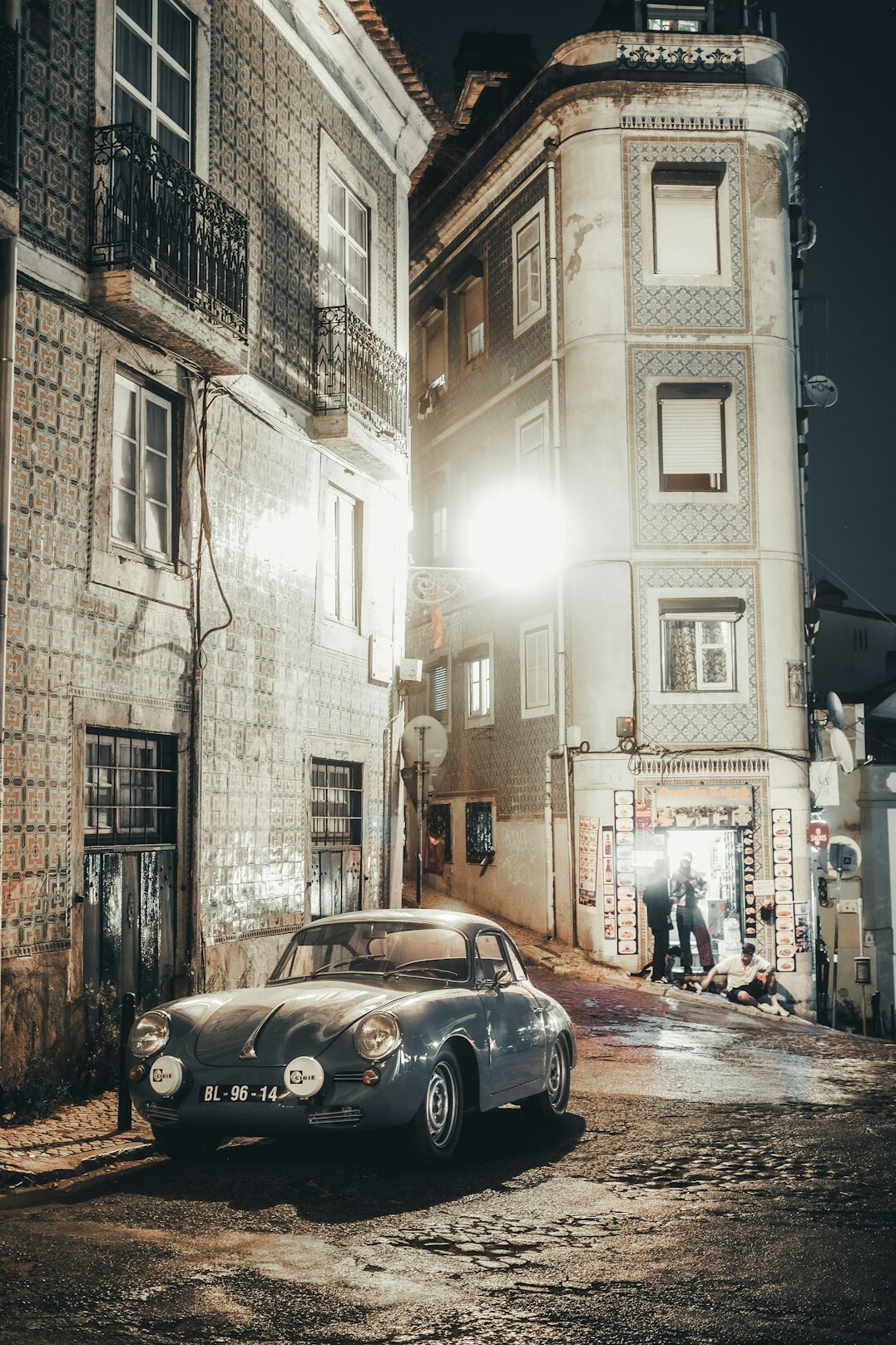 Vintage car parked on an old cobblestone street