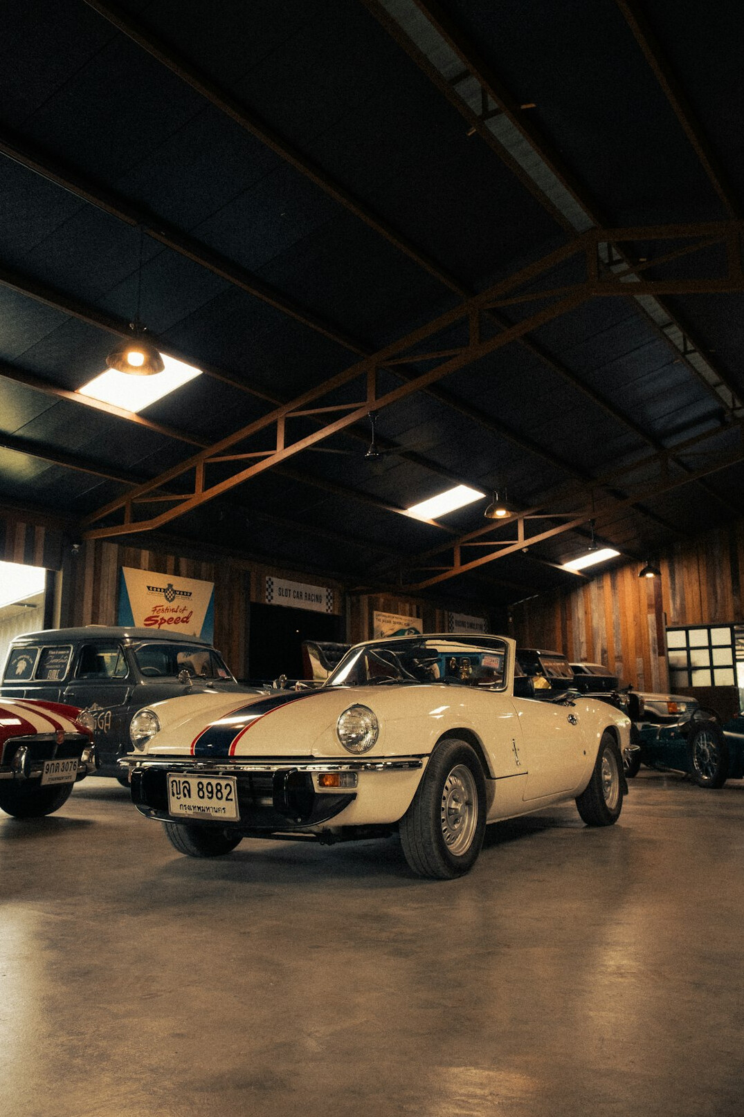 Row of classic automobiles inside a historic garage